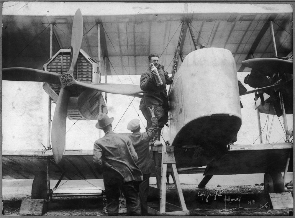 Captain John Alcock stowing provisions aboard Vickers Vimy aircraft before trans-Atlantic flight Jun 14 1919 wikimedia